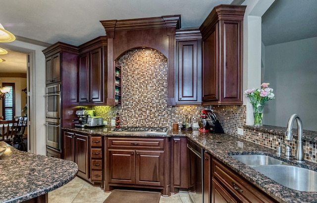407 Pickney Ave, Sugar Land, TX 77479 - kitchen featuring appliances with stainless steel finishes, ornamental molding, decorative backsplash, dark stone counters, and light tile patterned floors