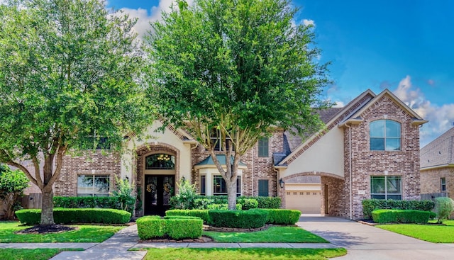 407 Pickney Ave, Sugar Land, TX 77479 - view of front of property with french doors, concrete driveway, an attached garage, and brick siding