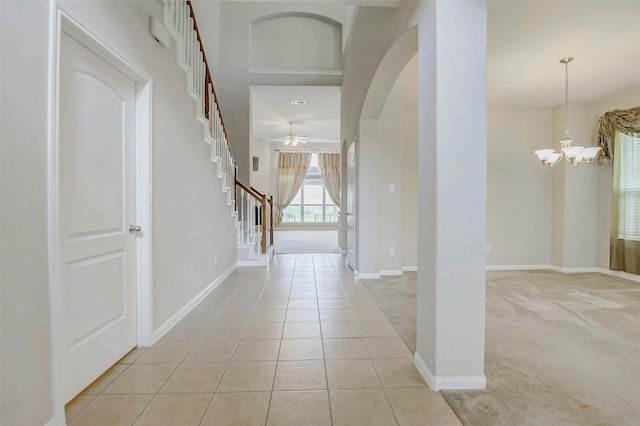 20311 Towering Cypress Dr, Cypress, TX 77433 - entryway with stairs, a chandelier, a ceiling fan, light tile patterned floors, and light colored carpet
