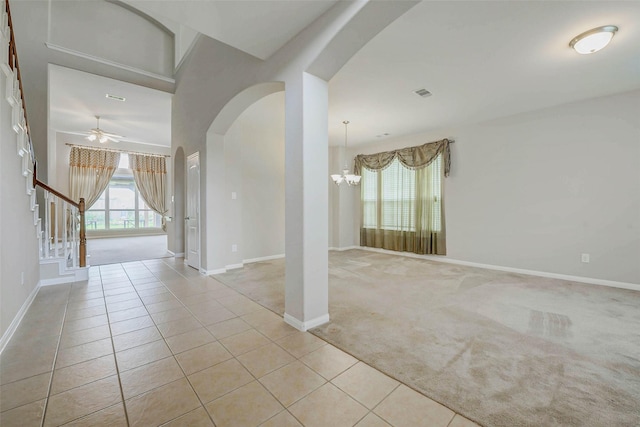 20311 Towering Cypress Dr, Cypress, TX 77433 - carpeted spare room with a chandelier, arched walkways, tile patterned floors, and stairs