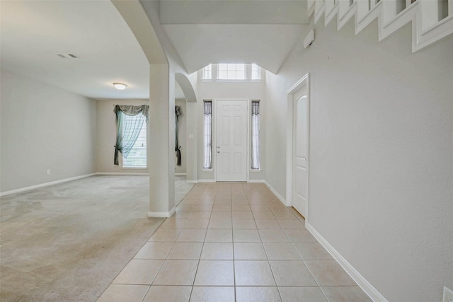 20311 Towering Cypress Dr, Cypress, TX 77433 - entryway featuring arched walkways, light tile patterned flooring, and light carpet