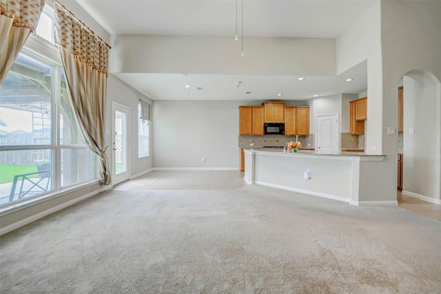 20311 Towering Cypress Dr, Cypress, TX 77433 - unfurnished living room with light carpet, arched walkways, and recessed lighting