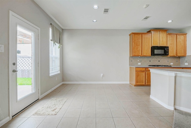 20311 Towering Cypress Dr, Cypress, TX 77433 - kitchen with black microwave, plenty of natural light, light countertops, tasteful backsplash, and recessed lighting