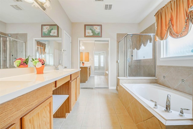 20311 Towering Cypress Dr, Cypress, TX 77433 - full bath with double vanity, a shower stall, a garden tub, and tile patterned floors