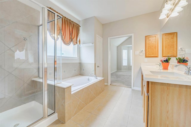 20311 Towering Cypress Dr, Cypress, TX 77433 - full bathroom featuring a garden tub, double vanity, a shower stall, and tile patterned flooring