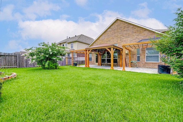 20311 Towering Cypress Dr, Cypress, TX 77433 - rear view of house with brick siding, a gazebo, a patio area, and a fenced backyard