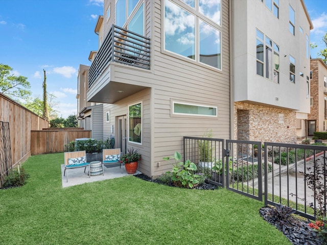 1437 Wagner St, Houston, TX 77007 - back of property with a balcony, a fenced backyard, a patio area, and stone siding