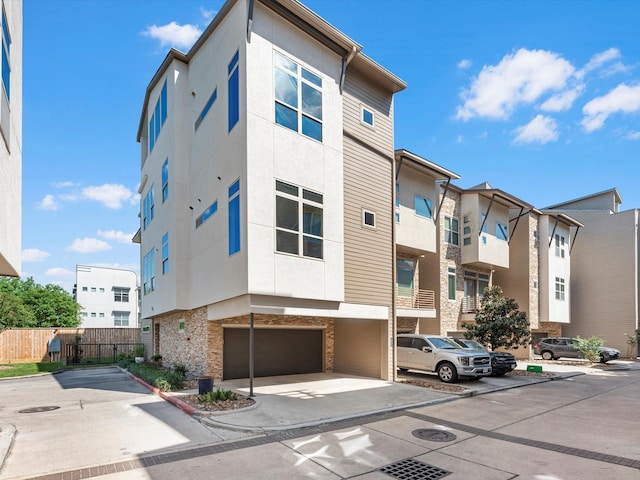 1437 Wagner St, Houston, TX 77007 - view of building exterior featuring a garage and concrete driveway