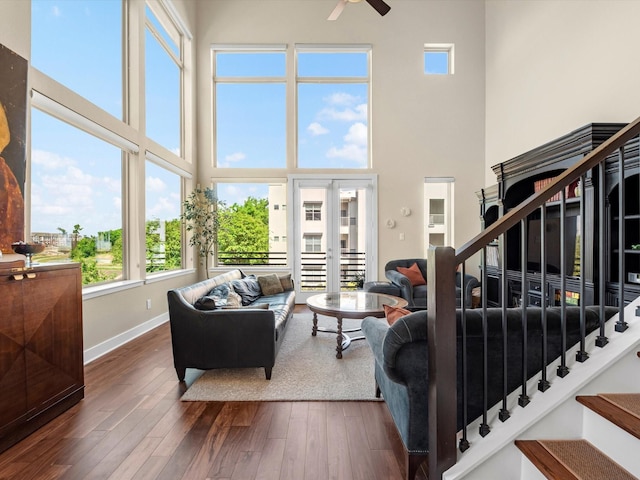 1437 Wagner St, Houston, TX 77007 - living area with ceiling fan, a high ceiling, wood finished floors, stairs, and french doors