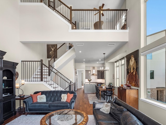1437 Wagner St, Houston, TX 77007 - living room featuring a towering ceiling, dark wood-style floors, stairway, plenty of natural light, and a ceiling fan