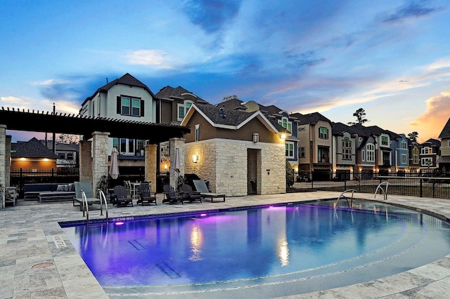 11005 Acorn Falls Dr, Houston, TX 77043 - pool at dusk featuring a community pool, a residential view, and a patio