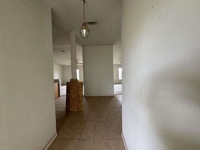 4425 Woodrow Rd, Lubbock, TX 79424 - hallway with tile patterned flooring and baseboards