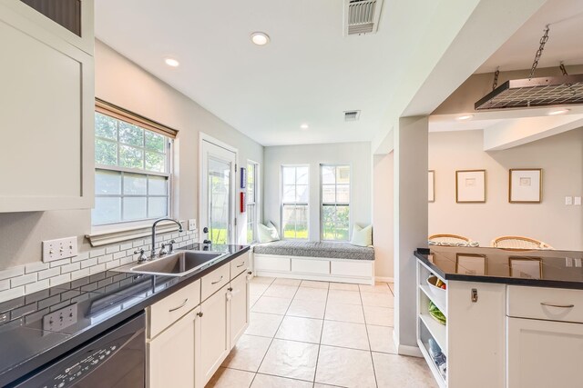 2018 Wakefield Dr, Houston, TX 77018 - kitchen with dishwasher, dark countertops, tasteful backsplash, white cabinetry, and open floor plan