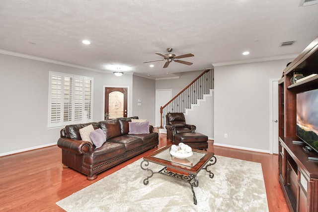2640 Couch St, Houston, TX 77008 - living room featuring wood finished floors, stairs, a ceiling fan, recessed lighting, and crown molding