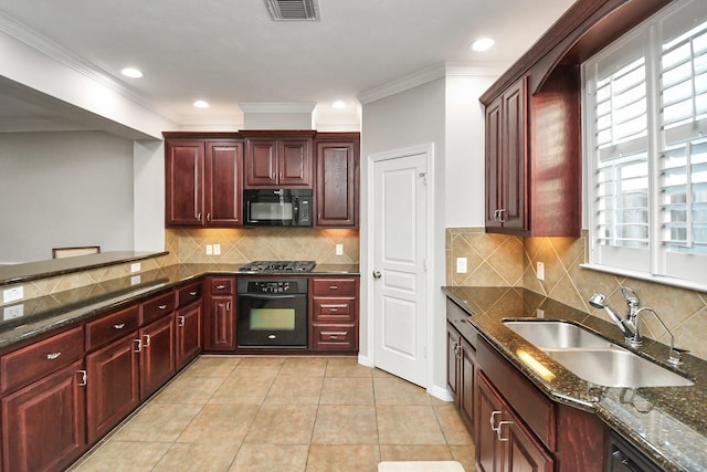 2640 Couch St, Houston, TX 77008 - kitchen with black appliances, dark brown cabinets, crown molding, dark stone countertops, and tasteful backsplash