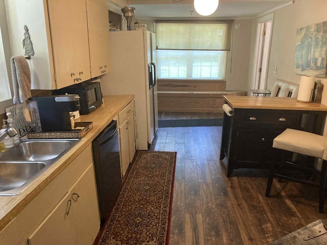 1305 E Goliad Ave, Crockett, TX 75835 - kitchen featuring black appliances, dark wood-style flooring, light countertops, and dark cabinets