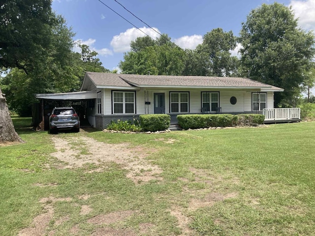 1305 E Goliad Ave, Crockett, TX 75835 - ranch-style house with a porch, an attached carport, driveway, and a front lawn