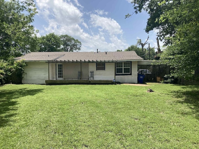 1305 E Goliad Ave, Crockett, TX 75835 - rear view of property featuring a lawn
