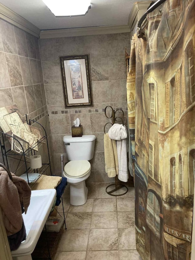 1305 E Goliad Ave, Crockett, TX 75835 - bathroom featuring ornamental molding, tile walls, and stone tile flooring