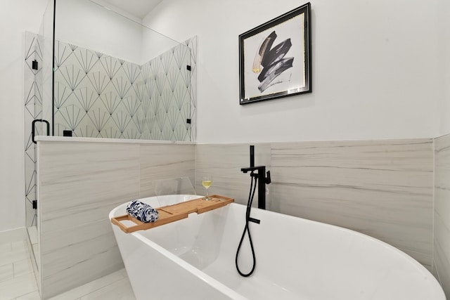 3913 Hare St, Houston, TX 77020 - full bathroom with tile walls, a freestanding tub, and a tile shower