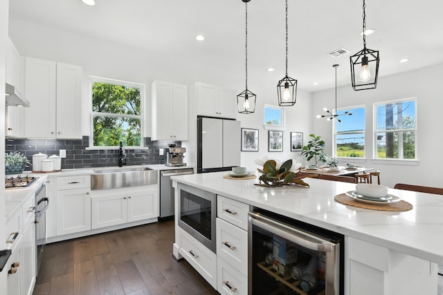 3913 Hare St, Houston, TX 77020 - kitchen featuring wine cooler, appliances with stainless steel finishes, recessed lighting, and white cabinetry