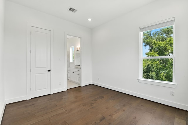 3913 Hare St, Houston, TX 77020 - unfurnished bedroom with multiple windows, dark wood-type flooring, recessed lighting, and ensuite bathroom