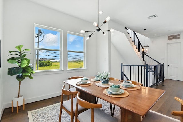 3913 Hare St, Houston, TX 77020 - dining area with a chandelier, dark wood-style flooring, recessed lighting, and stairs