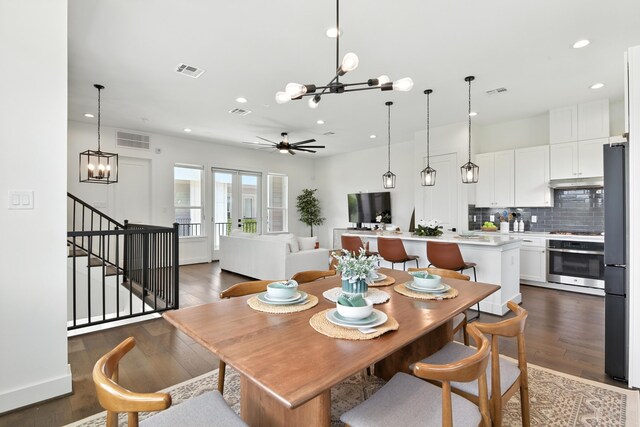 3913 Hare St, Houston, TX 77020 - dining room with a chandelier, recessed lighting, wood finished floors, stairs, and a ceiling fan