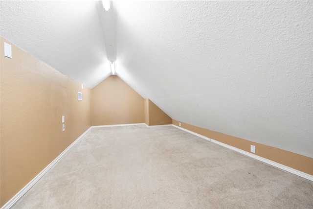 4838 Fair Oak Dale Ln, Humble, TX 77346 - bonus room with vaulted ceiling, light colored carpet, and a textured ceiling