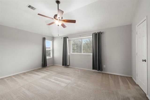 4838 Fair Oak Dale Ln, Humble, TX 77346 - unfurnished bedroom with lofted ceiling, light carpet, and a ceiling fan