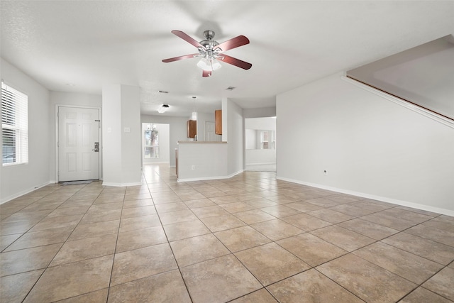 4838 Fair Oak Dale Ln, Humble, TX 77346 - unfurnished living room featuring a ceiling fan and light tile patterned flooring