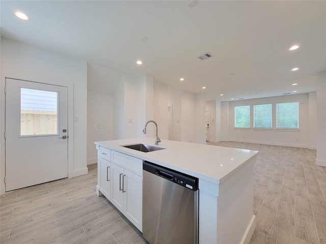 6735 Cohn St, Houston, TX 77091 - kitchen with dishwasher, white cabinetry, light wood-style flooring, a kitchen island with sink, and recessed lighting