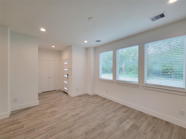6735 Cohn St, Houston, TX 77091 - empty room featuring light wood-style flooring and recessed lighting