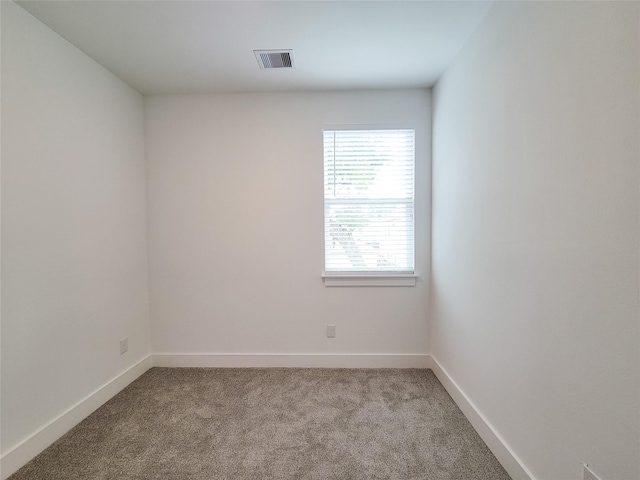 6735 Cohn St, Houston, TX 77091 - carpeted empty room with baseboards