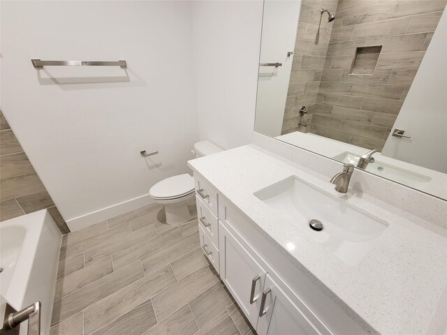 6735 Cohn St, Houston, TX 77091 - bathroom featuring vanity, tiled shower, wood tiled floors, and a tub to relax in