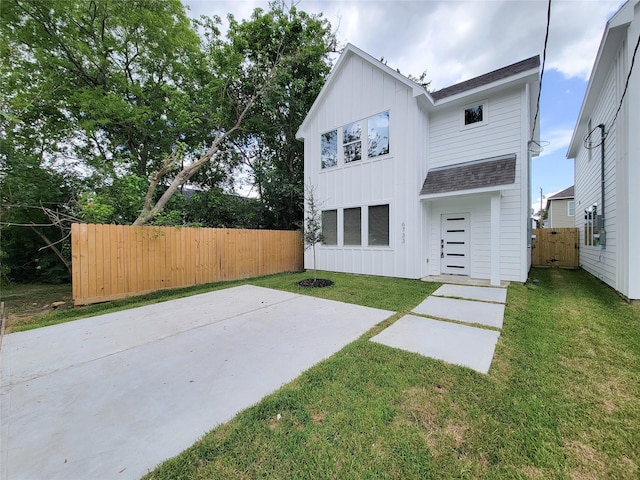 6735 Cohn St, Houston, TX 77091 - rear view of house with board and batten siding, roof with shingles, and a patio area