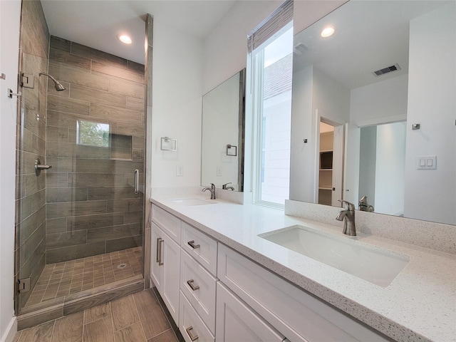 6735 Cohn St, Houston, TX 77091 - full bathroom with double vanity, a stall shower, and recessed lighting
