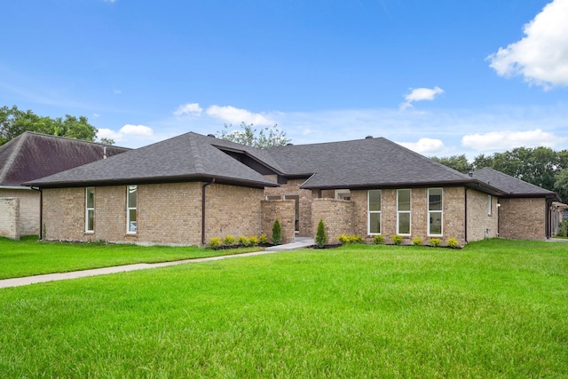 3351 S Sutton Sq, Stafford, TX 77477 - view of front of house with a front lawn, roof with shingles, and brick siding