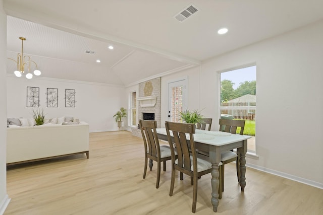 3351 S Sutton Sq, Stafford, TX 77477 - dining space featuring light wood finished floors, vaulted ceiling, a chandelier, recessed lighting, and a fireplace