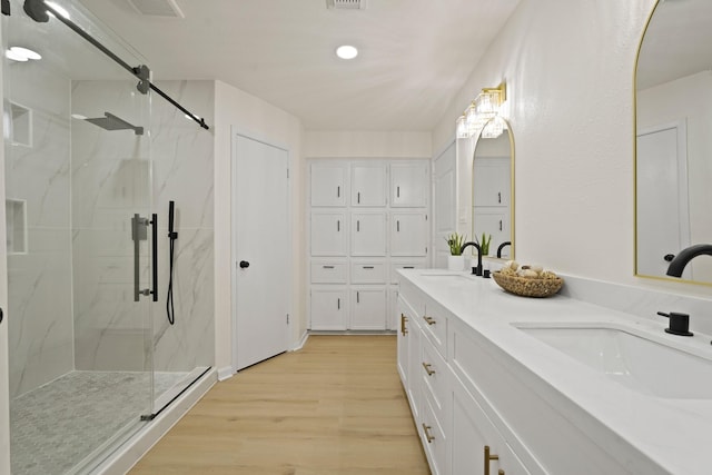 3351 S Sutton Sq, Stafford, TX 77477 - full bath featuring a marble finish shower, double vanity, wood finished floors, and recessed lighting