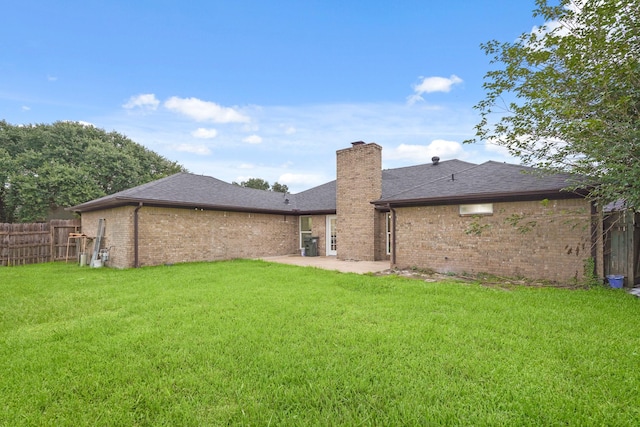 3351 S Sutton Sq, Stafford, TX 77477 - rear view of house with brick siding, a patio, a chimney, and roof with shingles