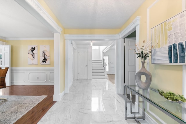 20234 Brondesbury Dr, Katy, TX 77450 - corridor featuring marble finish flooring, stairway, crown molding, and a wainscoted wall