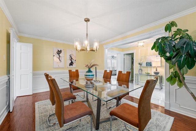 20234 Brondesbury Dr, Katy, TX 77450 - dining room with a chandelier, crown molding, wood finished floors, and wainscoting