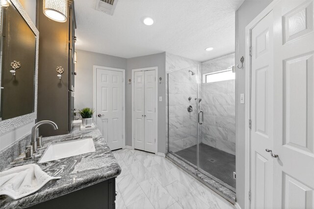 20234 Brondesbury Dr, Katy, TX 77450 - full bath with double vanity, a shower stall, marble finish floors, recessed lighting, and a textured ceiling