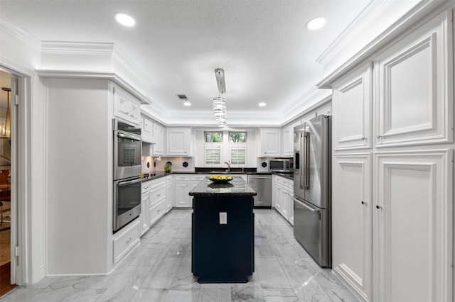 20234 Brondesbury Dr, Katy, TX 77450 - kitchen featuring appliances with stainless steel finishes, dark countertops, a kitchen island, white cabinetry, and ornamental molding
