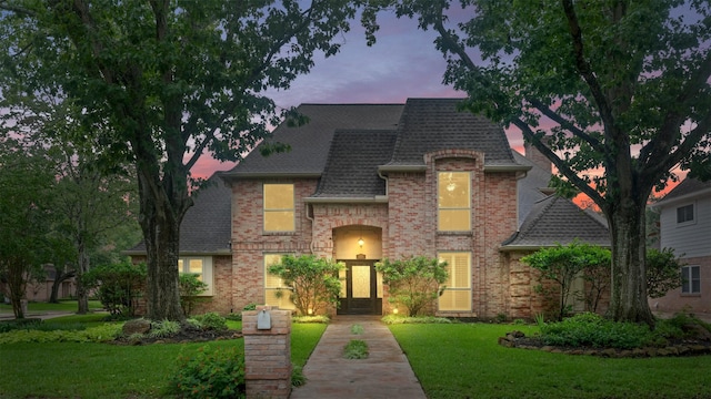 20234 Brondesbury Dr, Katy, TX 77450 - french country style house with roof with shingles, a lawn, and brick siding