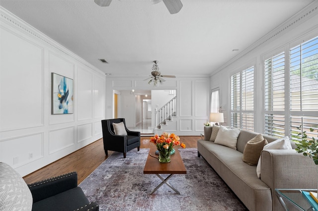 20234 Brondesbury Dr, Katy, TX 77450 - living area featuring a decorative wall, ceiling fan, wood finished floors, ornamental molding, and stairway
