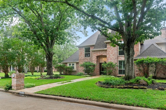 20234 Brondesbury Dr, Katy, TX 77450 - view of front facade featuring brick siding, roof with shingles, and a front yard
