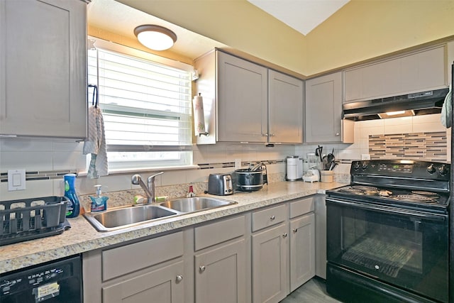 206 Galleon Dr, Freeport, TX 77541 - kitchen with black appliances, under cabinet range hood, decorative backsplash, and light countertops