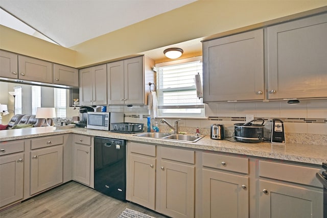 206 Galleon Dr, Freeport, TX 77541 - kitchen featuring black dishwasher, gray cabinetry, tasteful backsplash, plenty of natural light, and vaulted ceiling